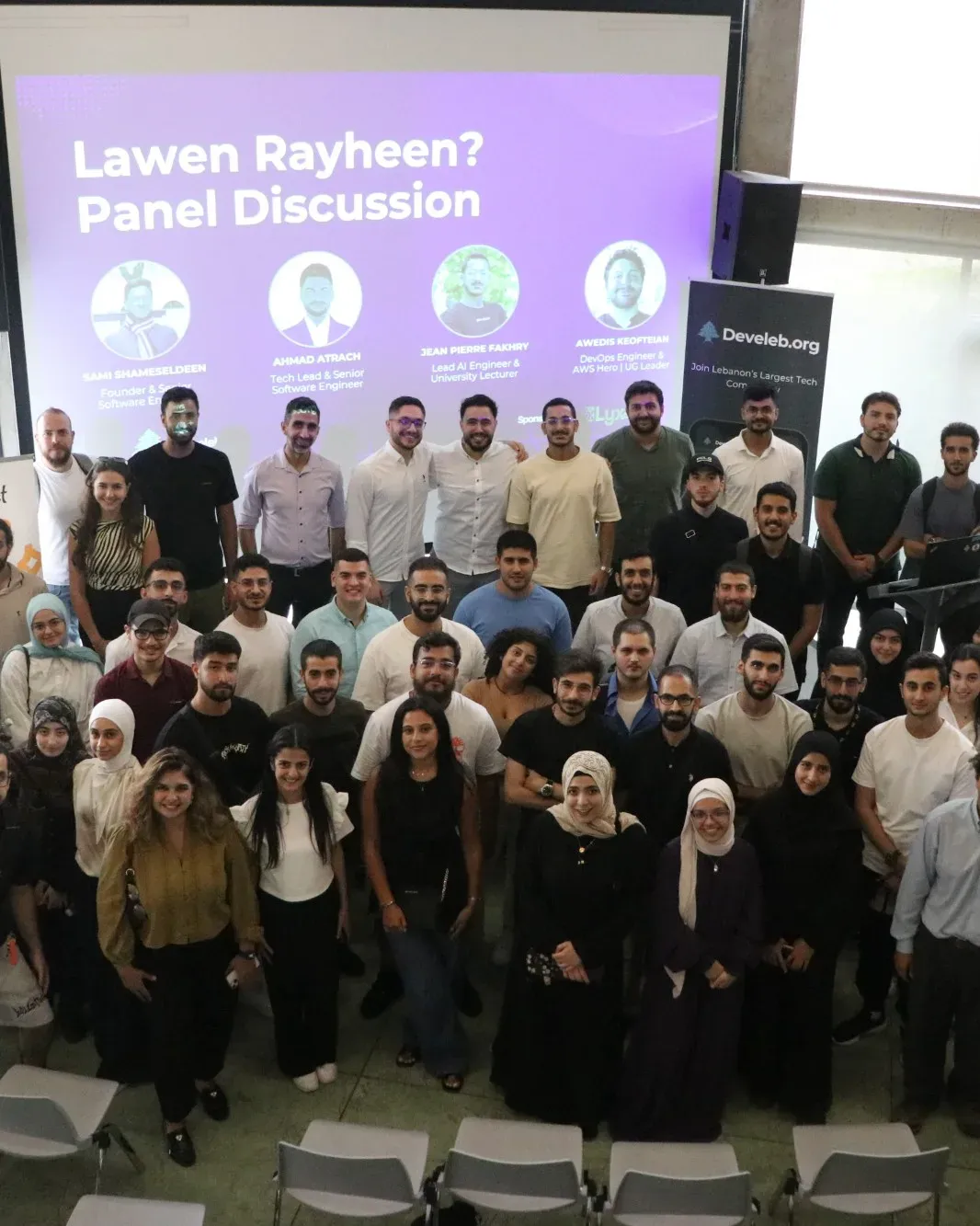 Group photo of the Develeb community under the Lawen Rayheen? panel discussion screen