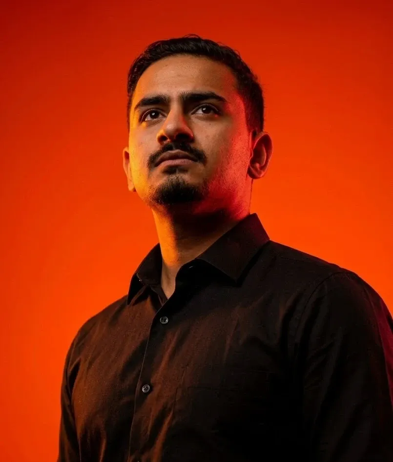 Mohammad Al Rez, known as Rice, lit in orange and looking up